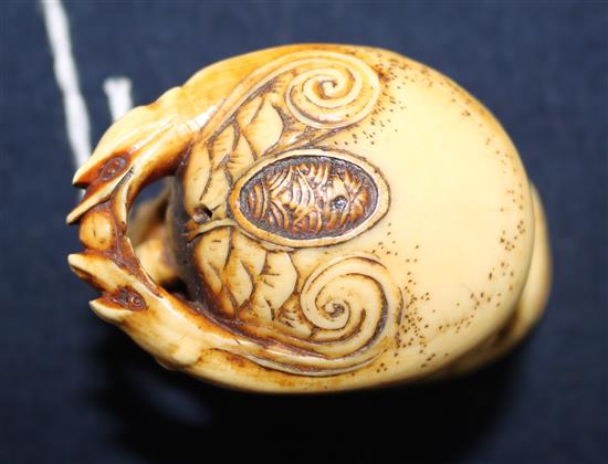 A carved ivory of figures under a crab